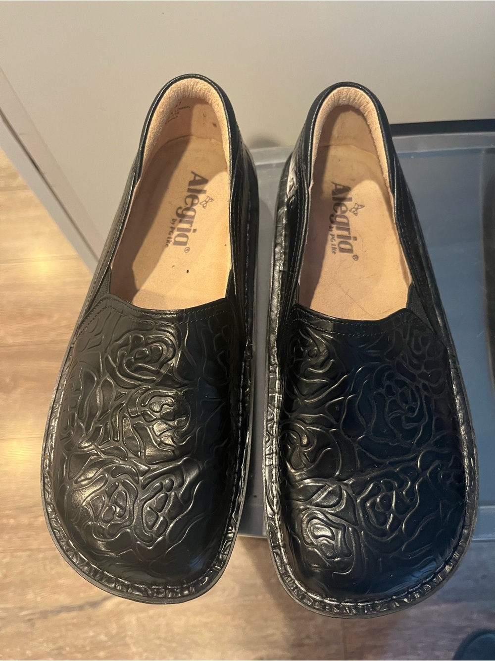 Alegria Black Floral-Embossed Slip-On Shoes